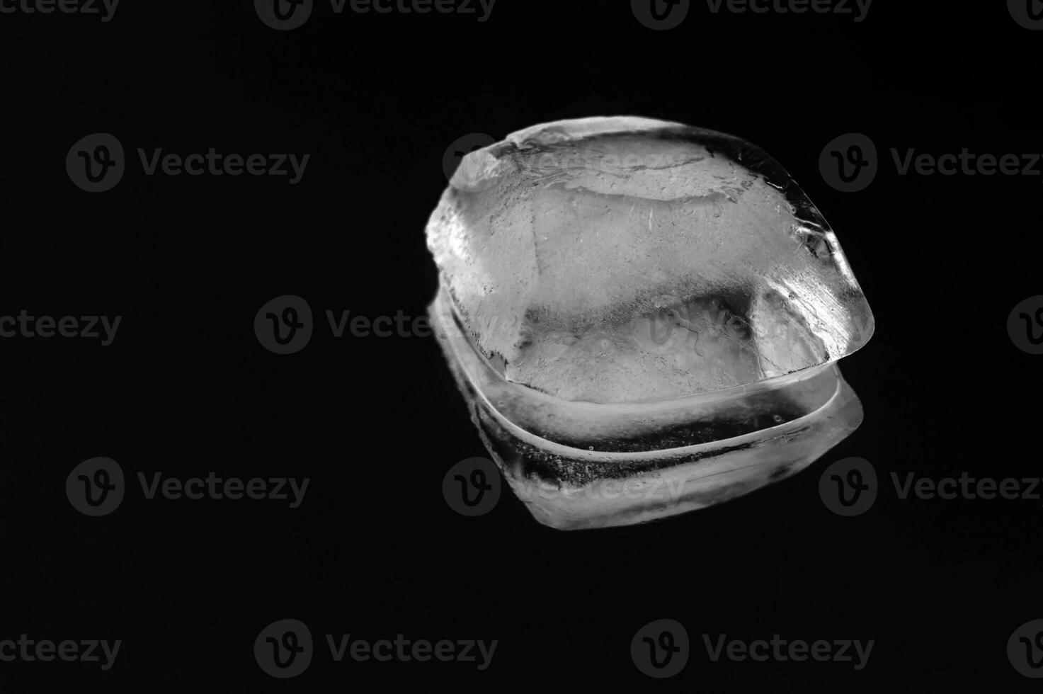 Melting net piece of ice on a black background. photo