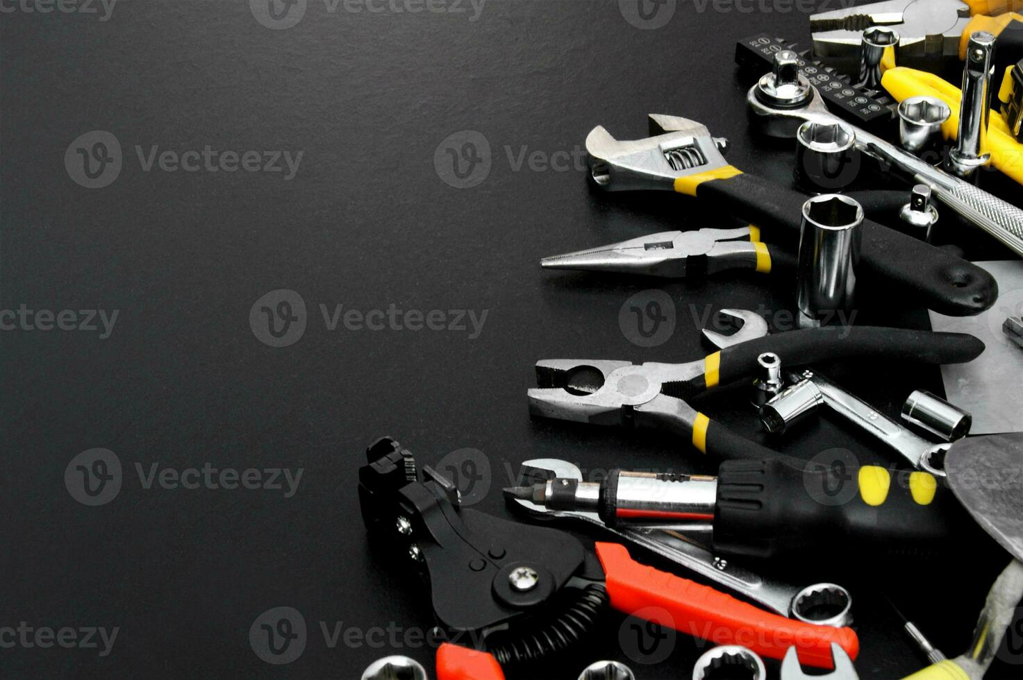 Many different tools for repair work on a black background with copy space for text. photo