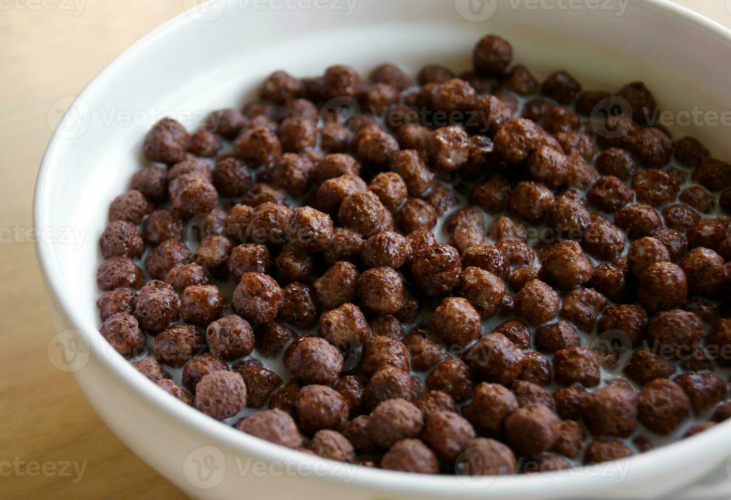 White plate with chocolate cereal for breakfast. photo