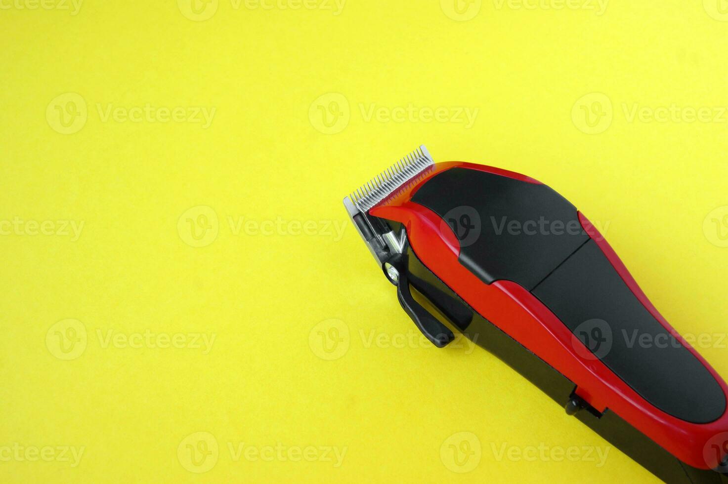 Hair clipper close-up on a yellow background. photo