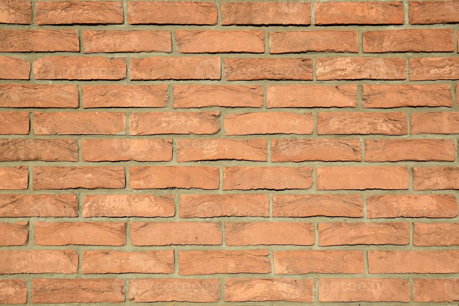 Old, bright, reliable and strong orange brick wall texture. photo