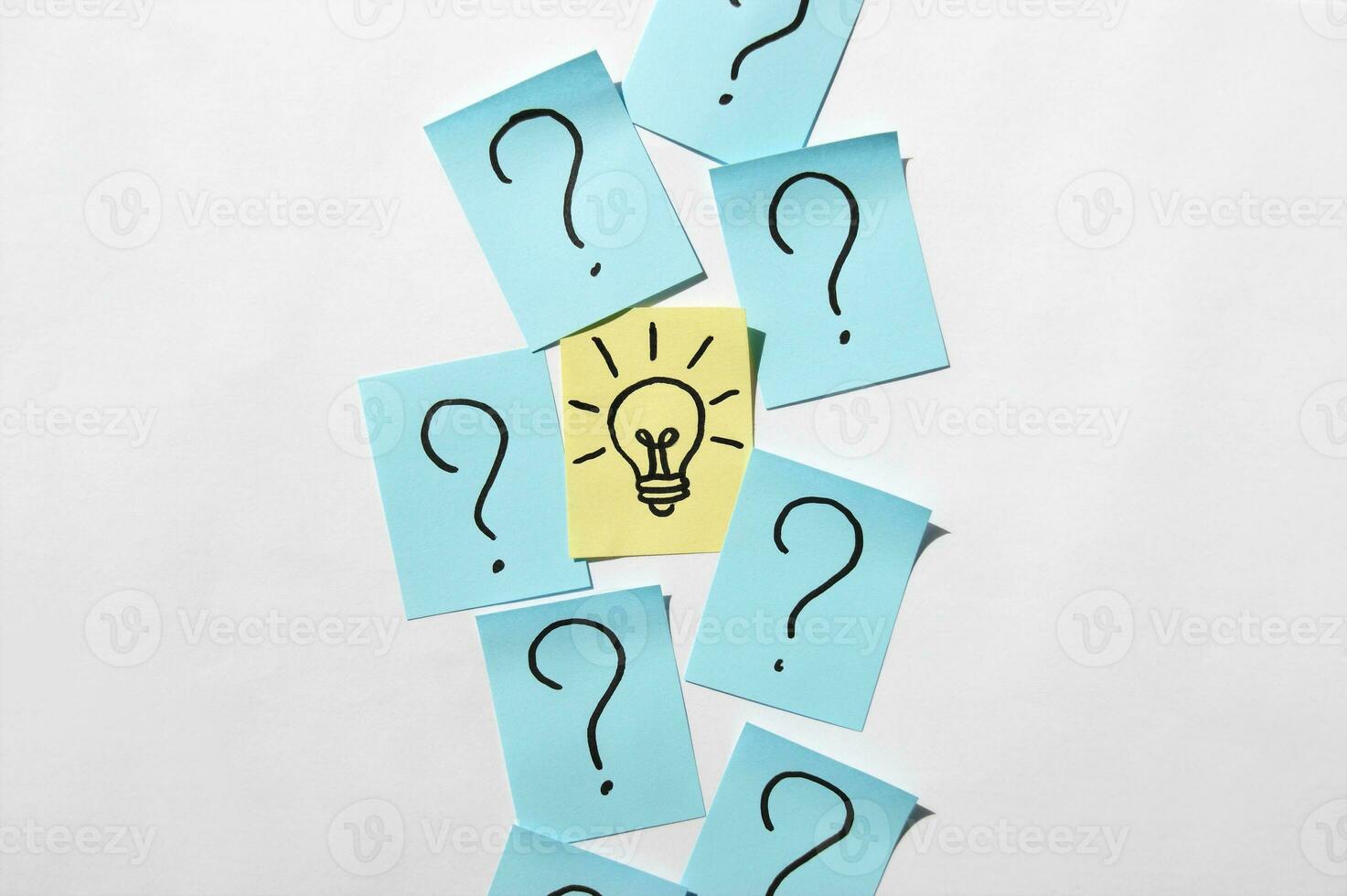 Stickers with question marks and a single light bulb as a sign of a good idea. photo