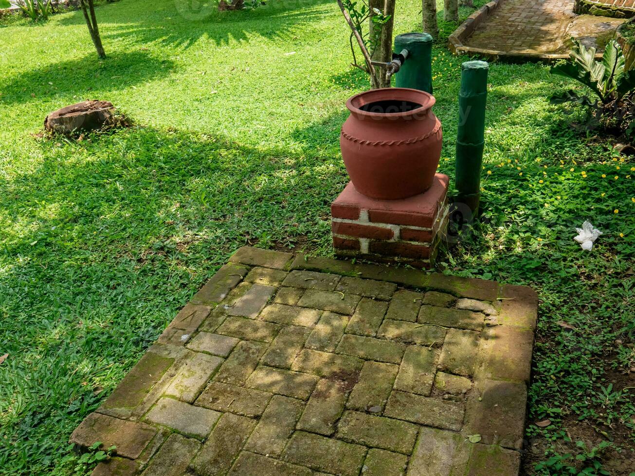 traditional water barrel placed in the garden photo