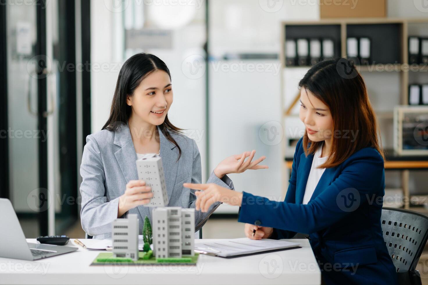 Signing a contract. Client and broker agent, lease agreement, successful deal and  Young business sitting in office photo