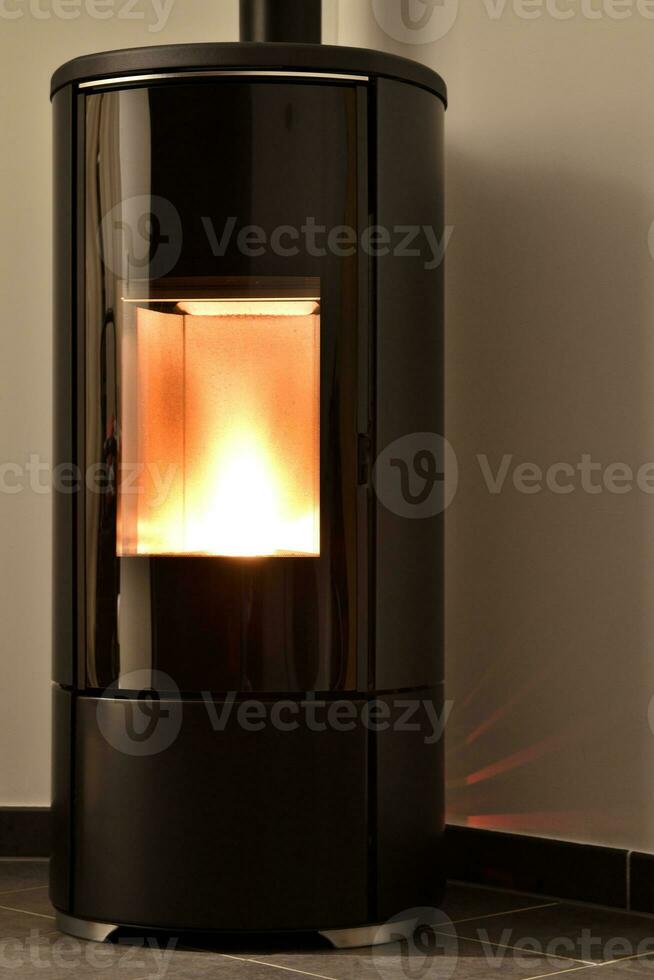 Modern domestic pellet stove, granules stove with flames photo