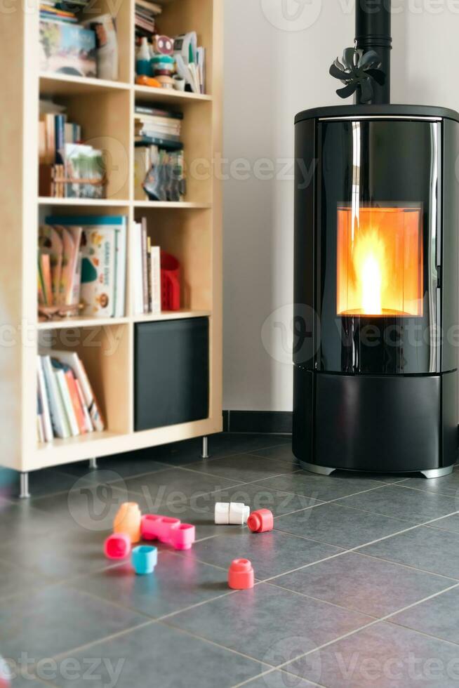 Pellet stove with some toys in front, with flames and library photo