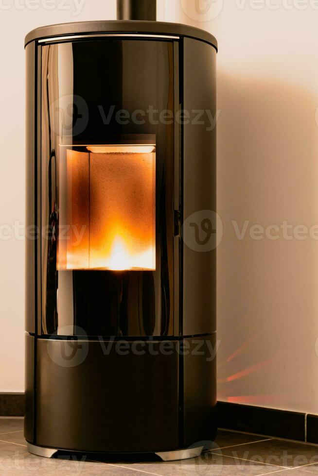 Modern domestic pellet stove, granules stove with flames photo