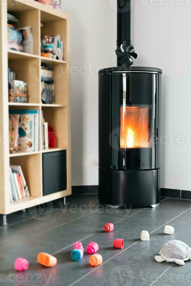 Pellet stove with some toys in front, with flames and library photo