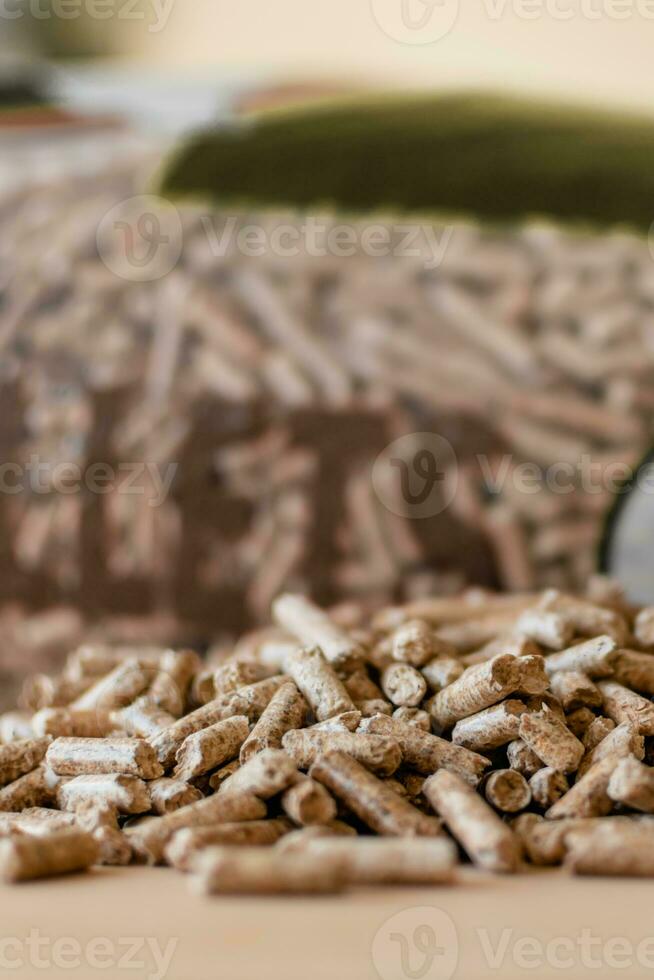 Pile of pellets with bag of granules in the background photo