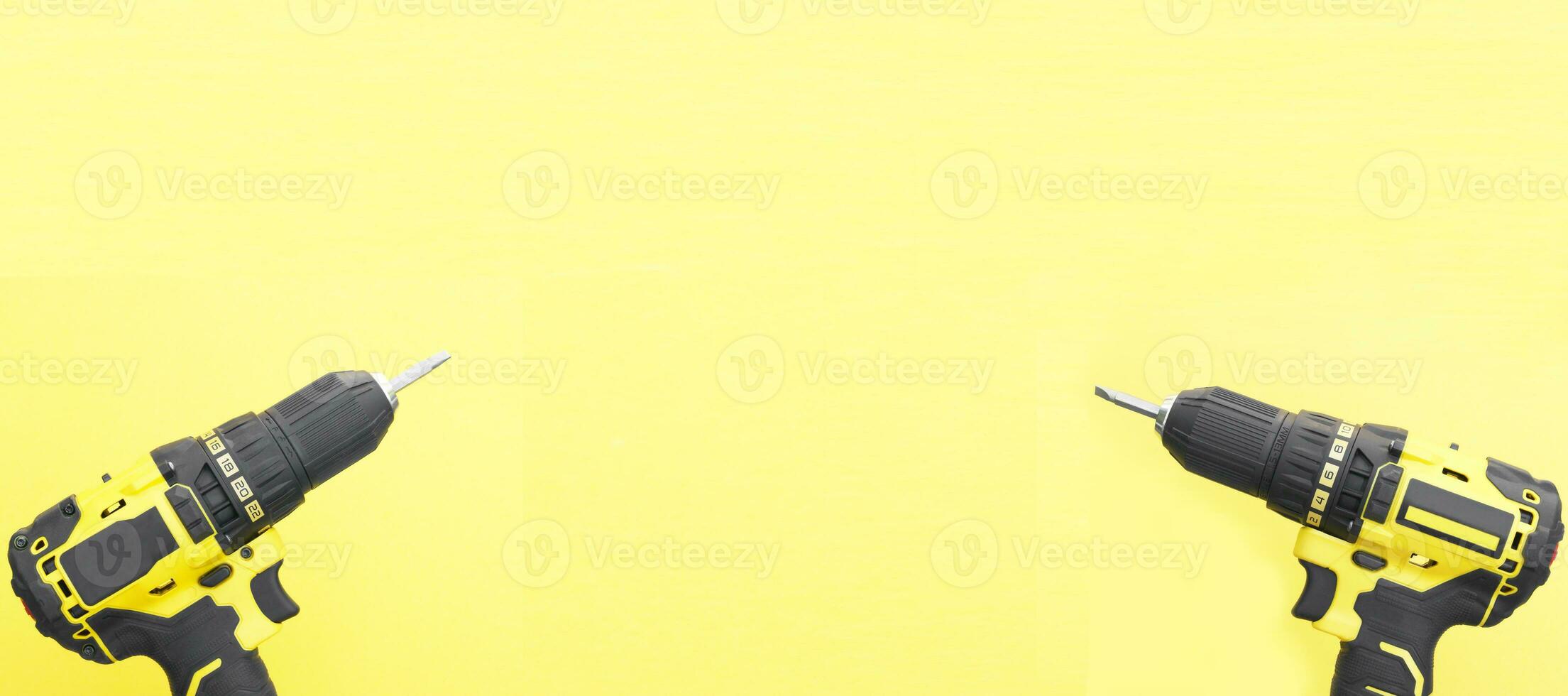 Yhe yellow-black screwdriver on a yellow background. photo
