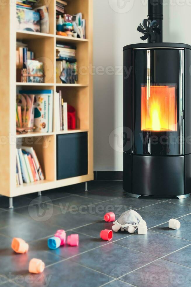 Pellet stove with some toys in front, with flames and library photo