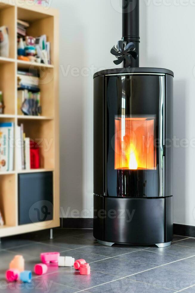 Pellet stove with some toys in front, with flames and library photo