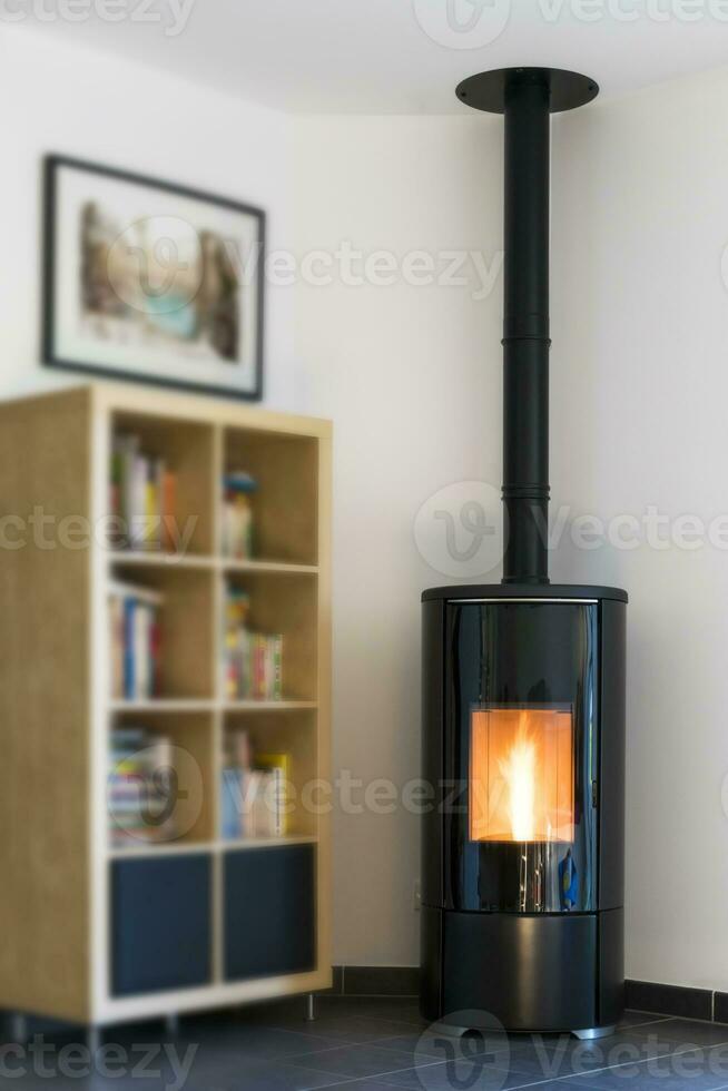 Modern domestic pellet stove, granules stove with flames and library photo