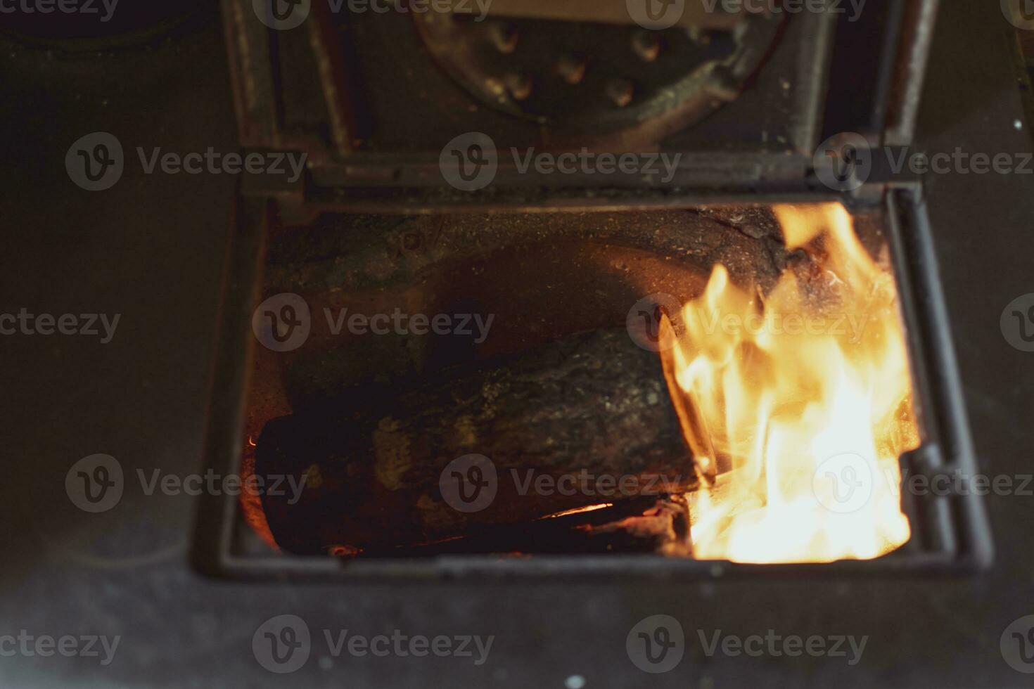 Cookstove opened with wood flames which are burning photo