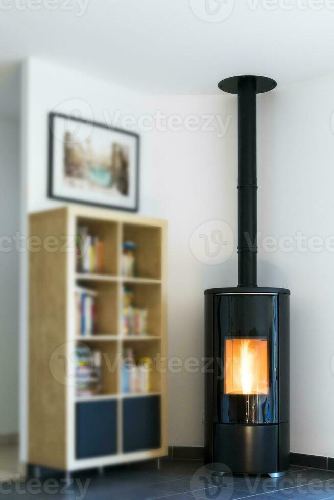 Modern domestic pellet stove, granules stove with flames and library photo