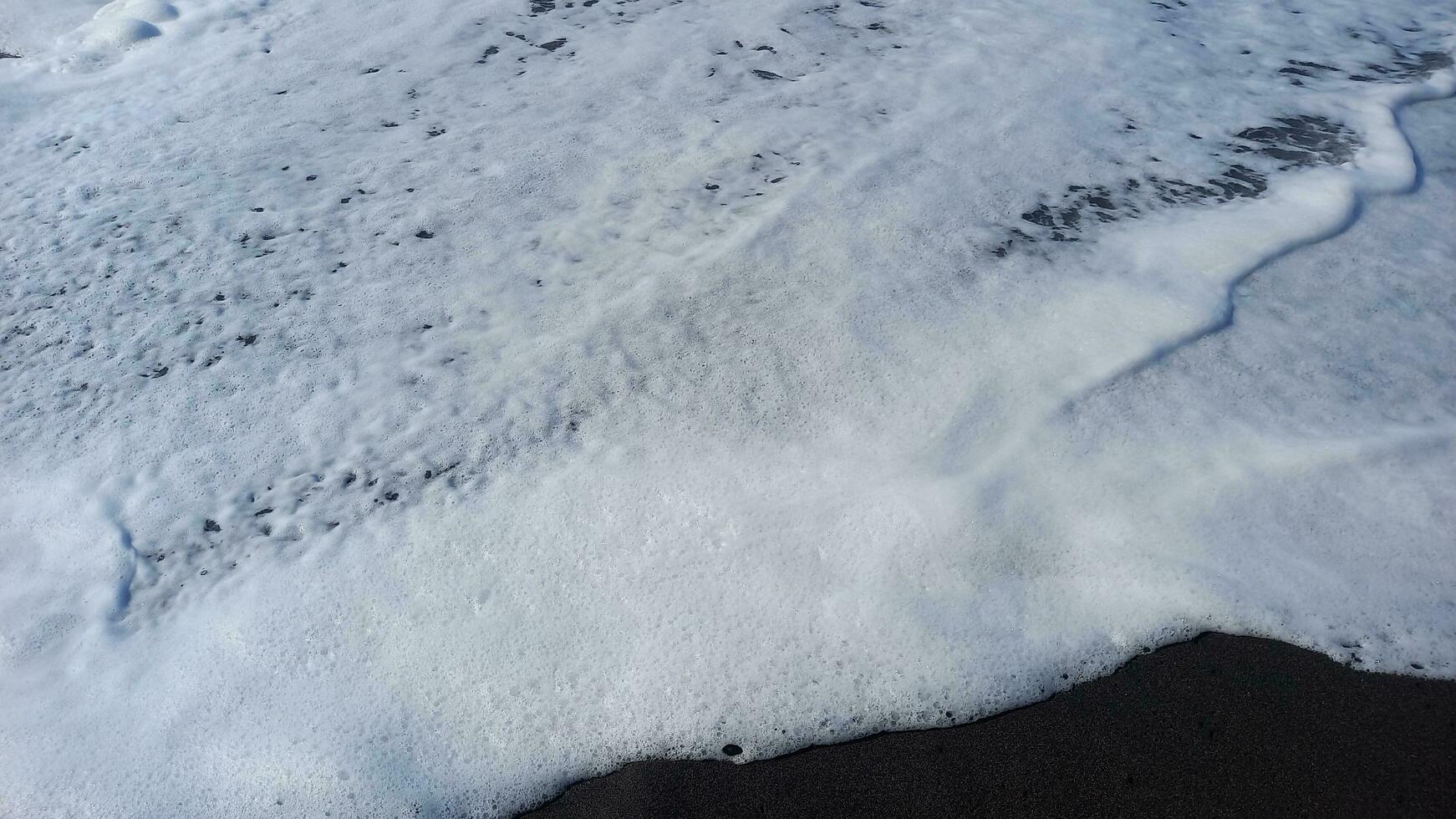 Gentle waves at sandy beach. photo