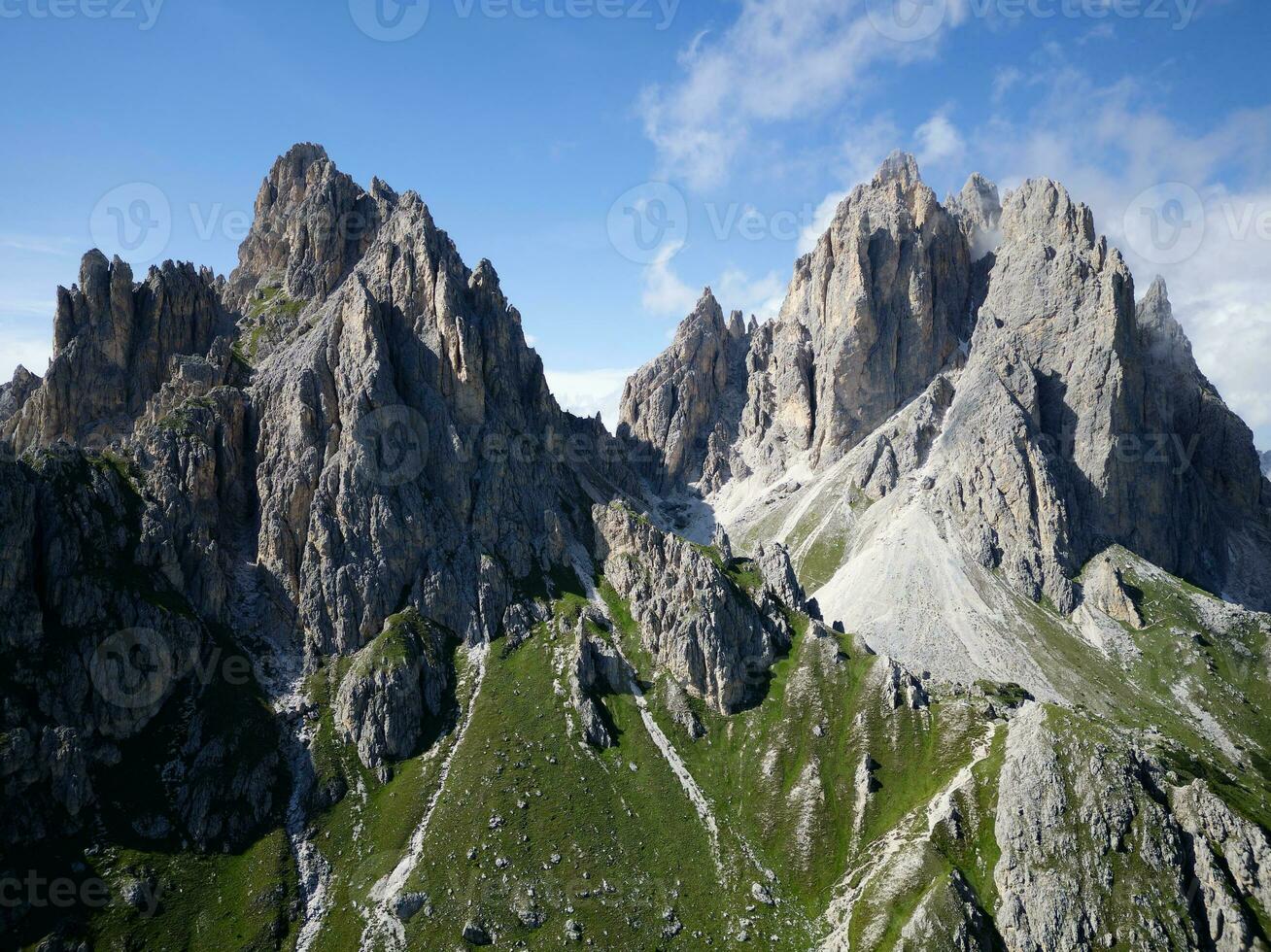 Aerial view of Cadini di Misurina mountains during a sunny day with some clouds. Dolomites, Italy. Dramatic and cinematic landscape. photo