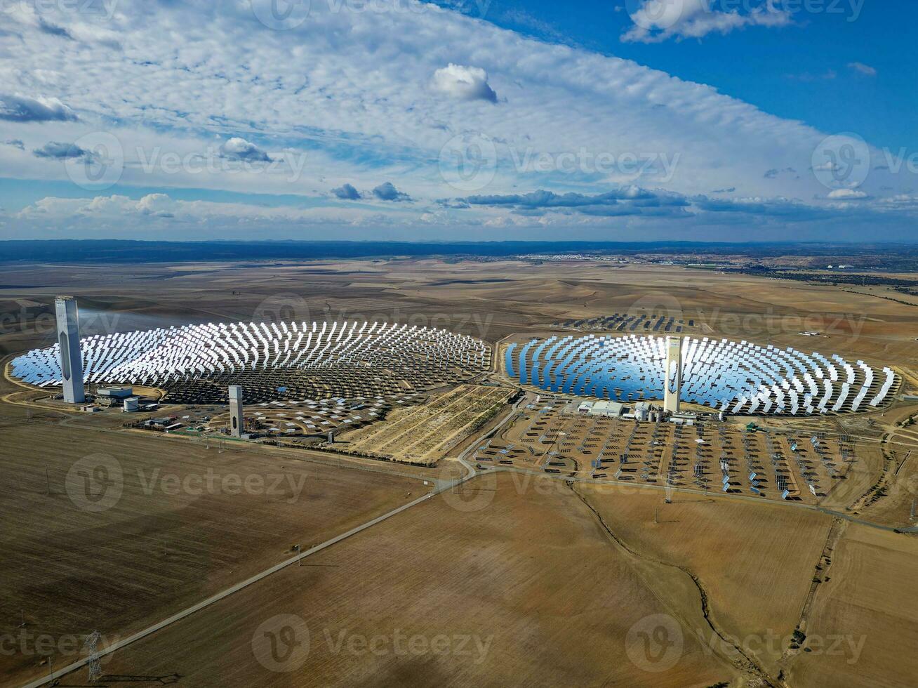 Aerial view of the Solar Power Towers PS10 and PS20 in Sanlucar la Mayor, Seville. Spain's stunning solar energy plant.  Concentrated solar power plant. Renewable energy. Green energy. photo