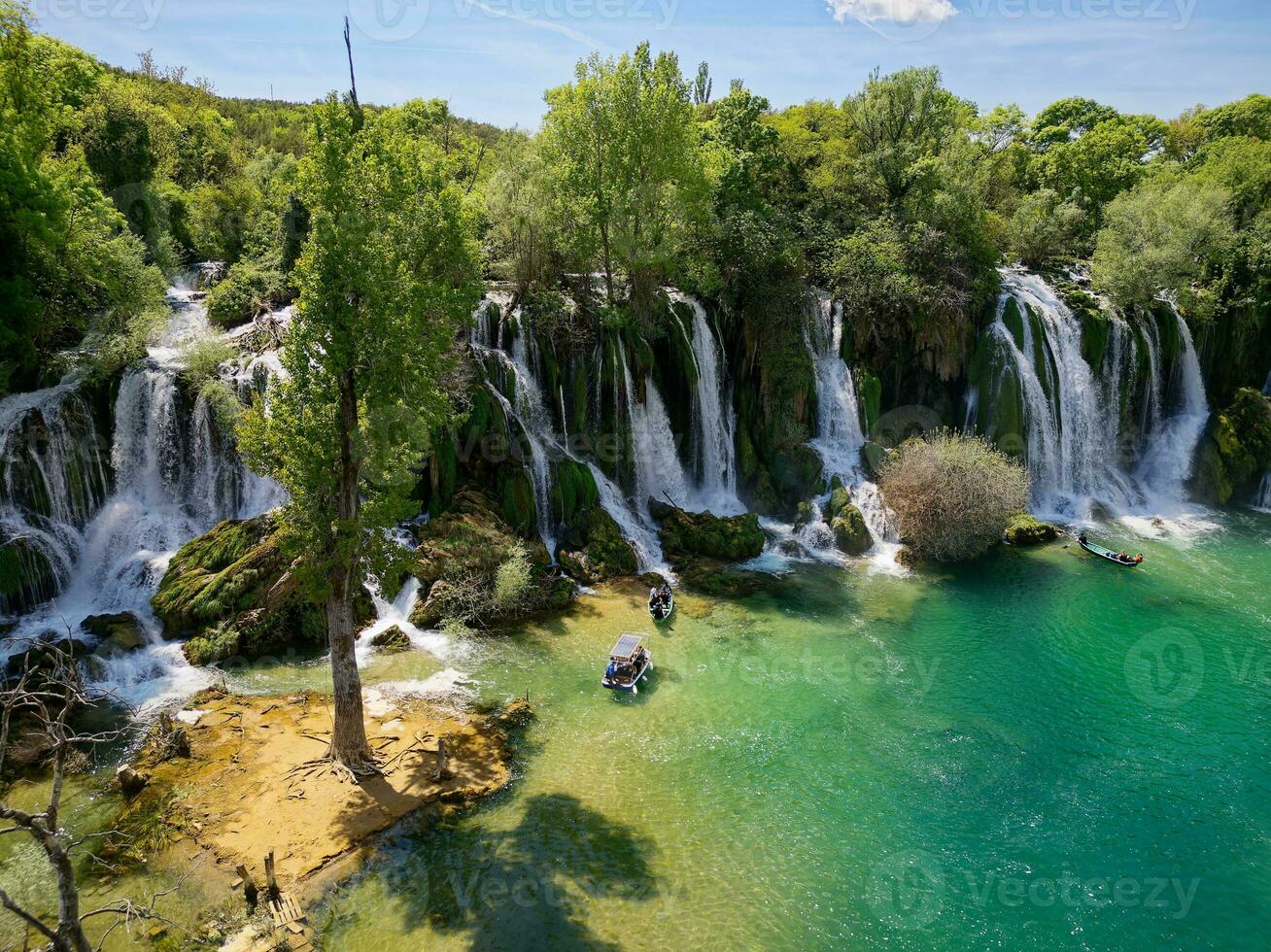 Aerial view of Kravica Waterfall in Bosnia and Herzegovina. The Kravica waterfall is a pearl of the Herzegovinian landscape. It is a unique natural beauty in the Trebizat River. Oasis in stone. photo