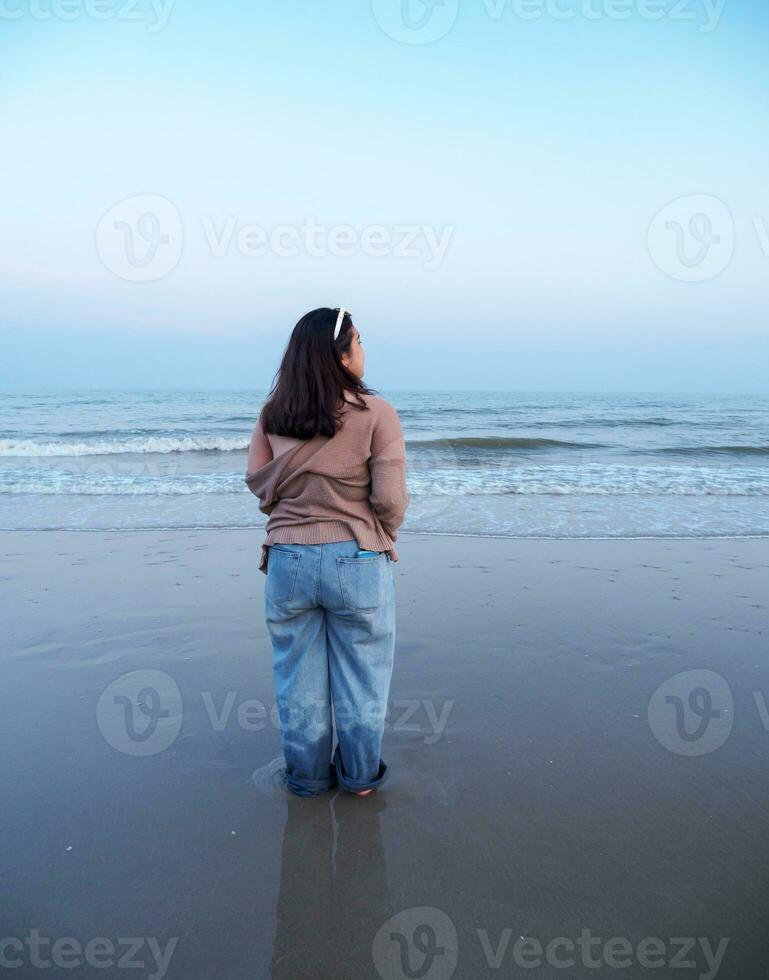 Portrait young woman asian chubby cute beautiful one person in front viewpoint tropical sunset sea beach white sand clean and blue sky background calm Nature ocean Beautiful wave water travel photo