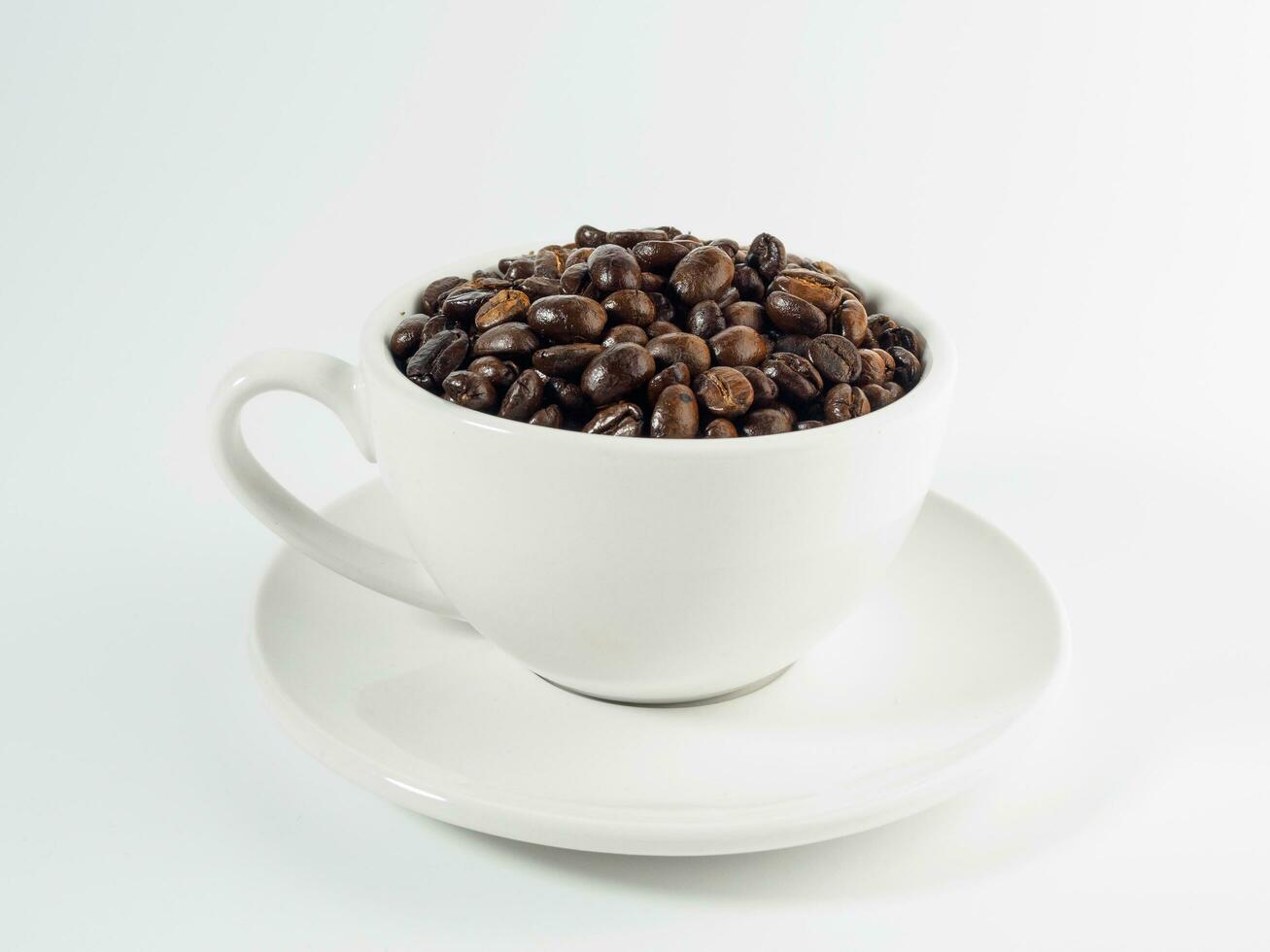 Roasted Arabica coffee beans, ready to make coffee that people like to drink. Placed in a white coffee cup on the background. Looks beautiful and appetizing. Drink. photo