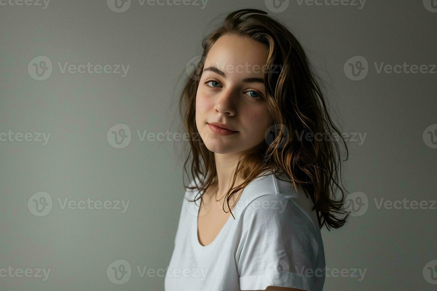 AI generated A casual girl in denim and a white tee standing against a seamless gray background photo