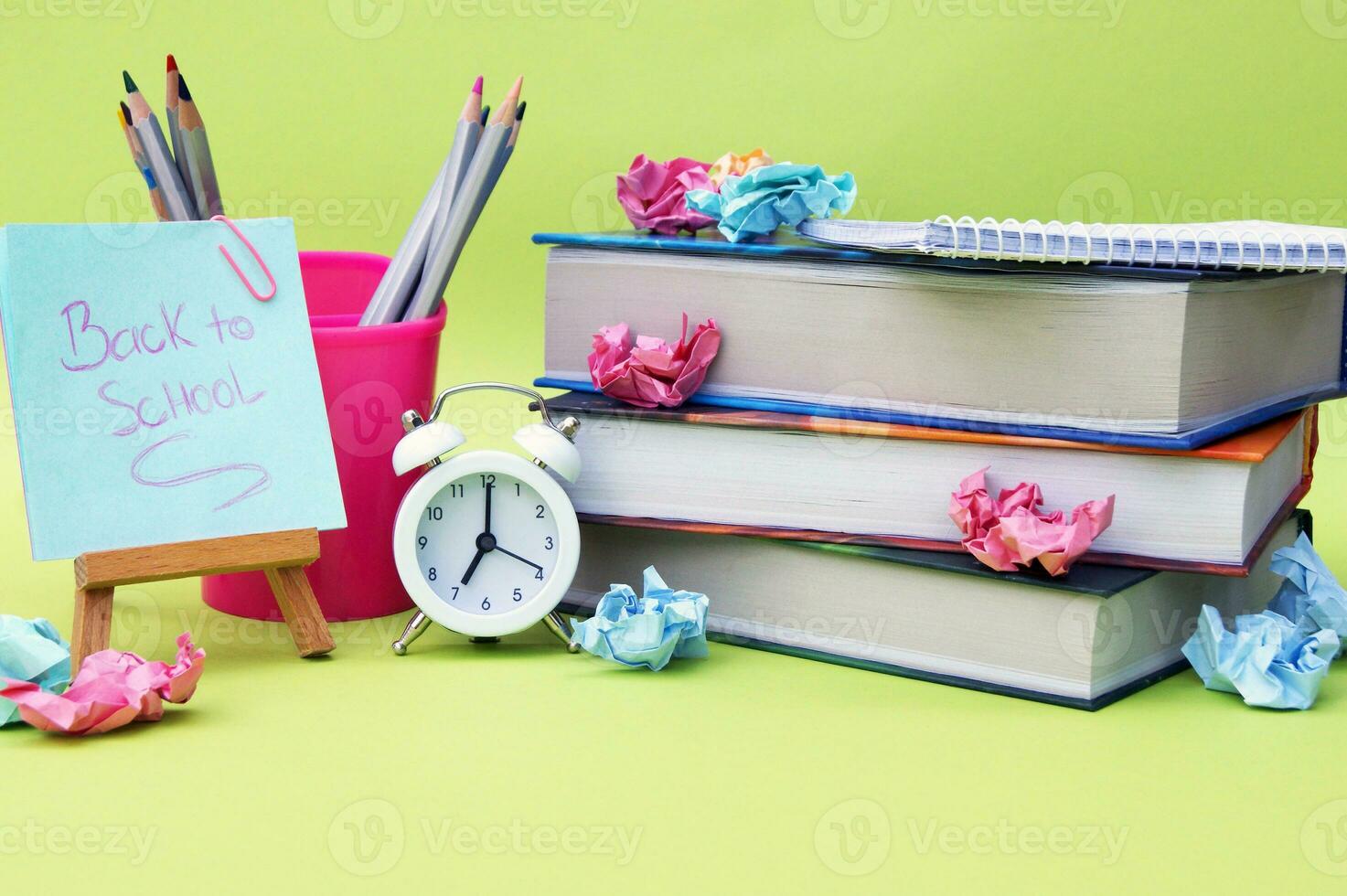 A small easel with a sticker with the inscription Back to School on the background of the educational installation. photo