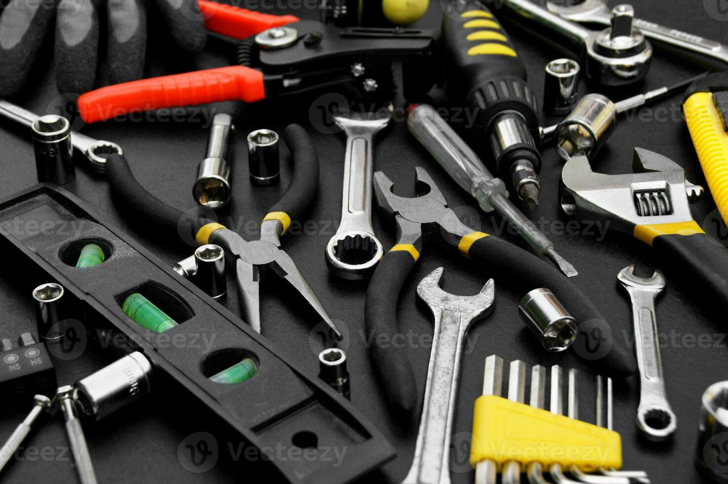 Many different tools for repair work on a black background. photo