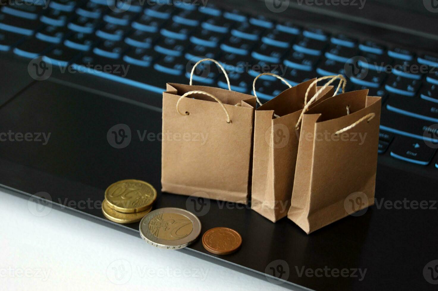 Small craft bags for purchases on the background of the keyboard. photo
