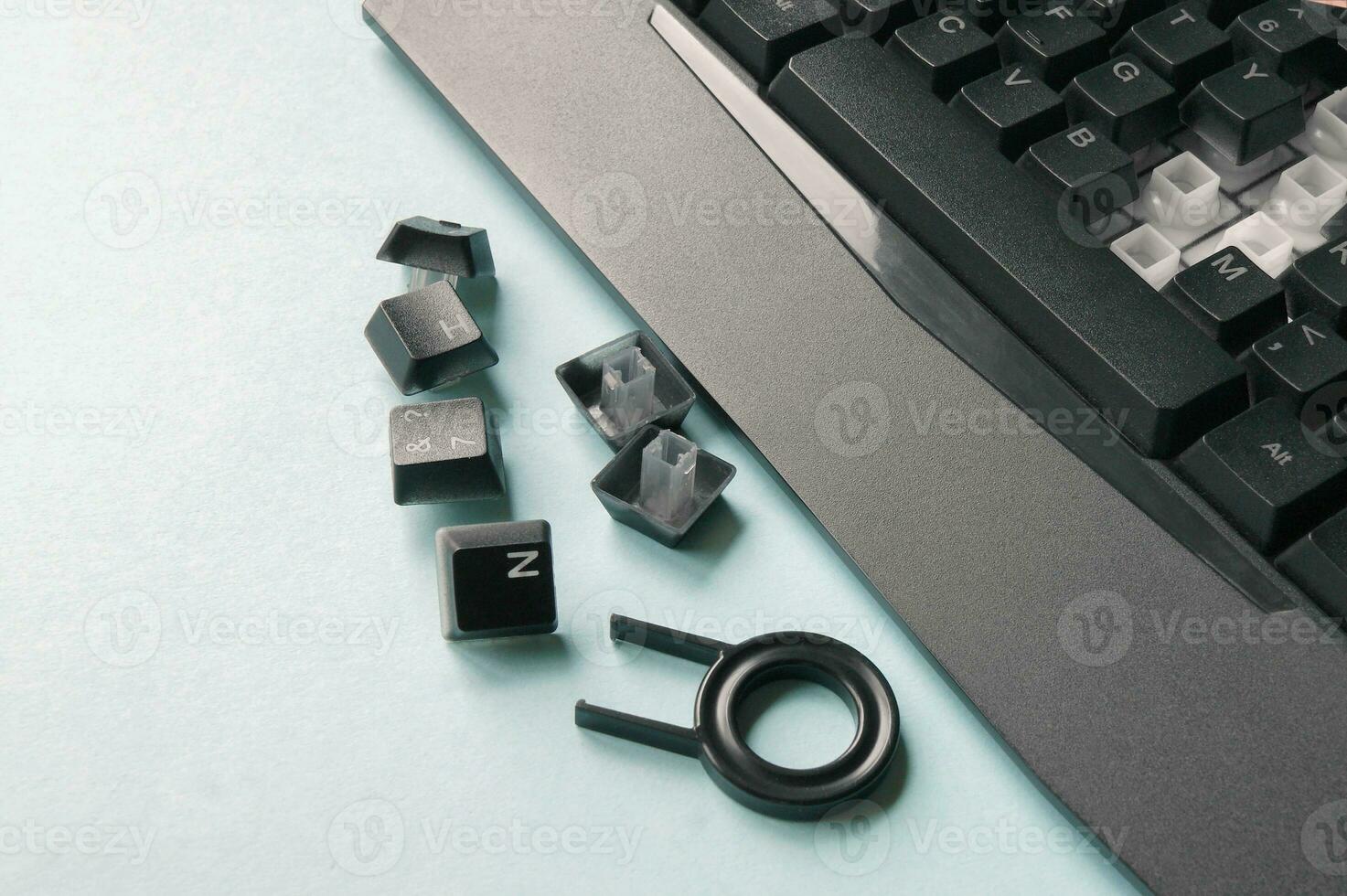 Keyboard, keys, brushes and key for replacing keys on a blue background. photo
