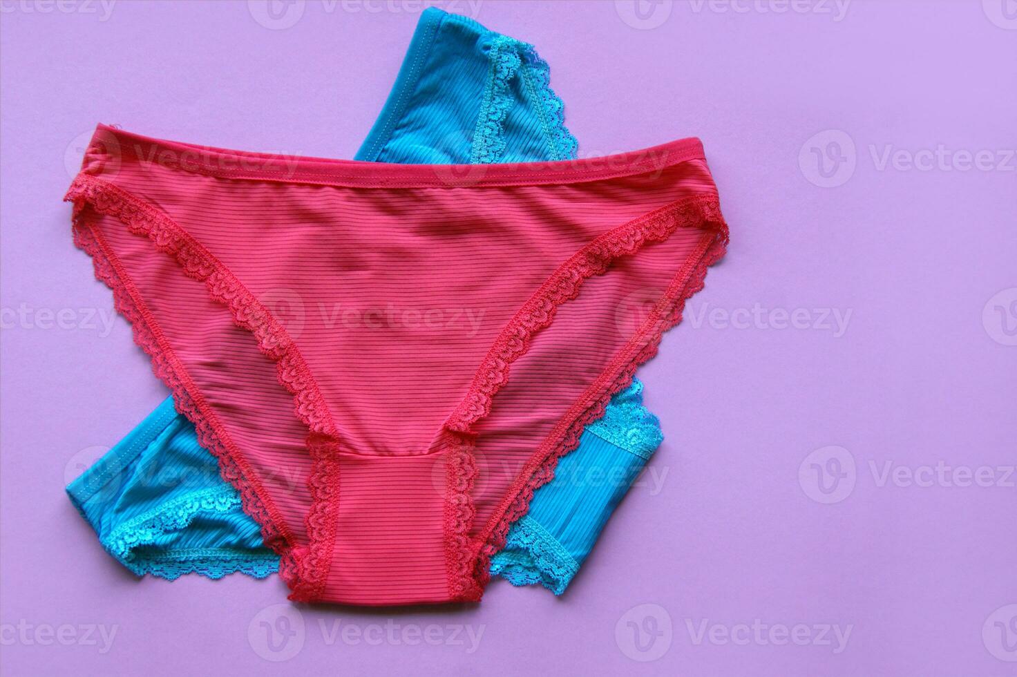 Set of women's panties on a pink background. Pink and blue underwear. photo
