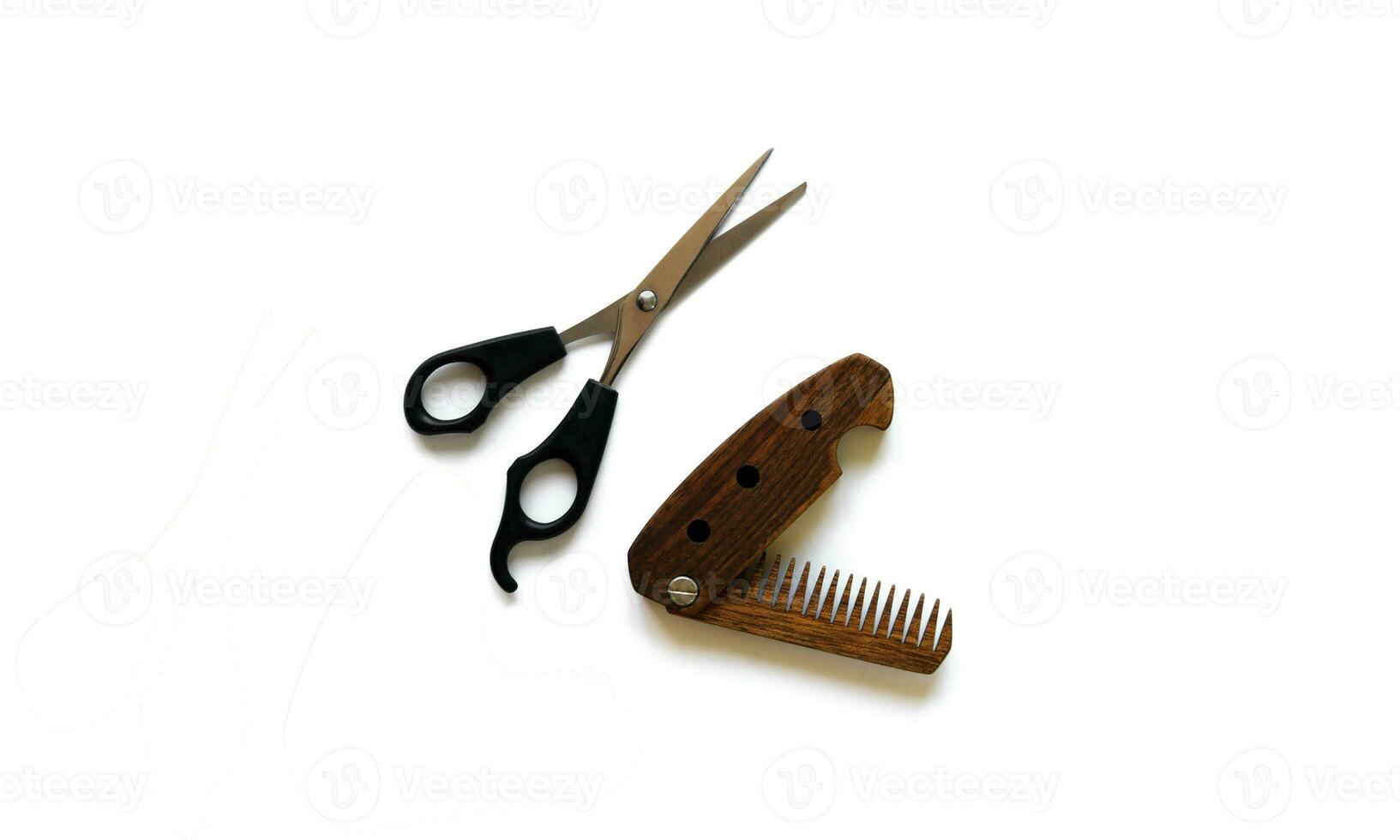 Male wooden comb and scissors for a haircut isolated on a white background. photo