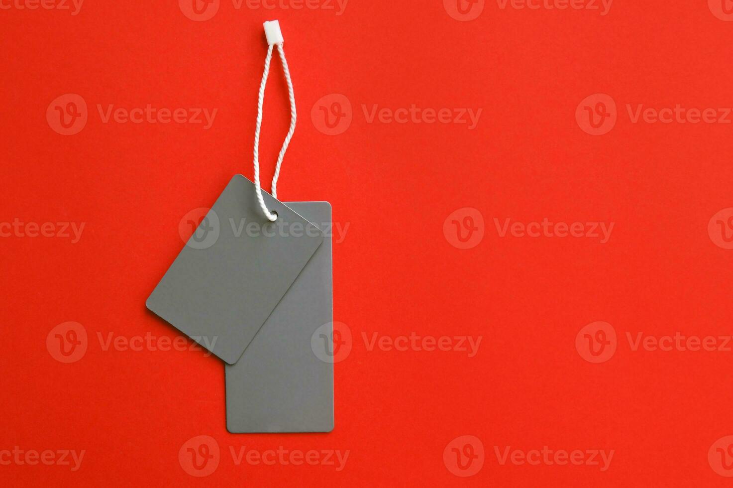 Two empty gray tags on a orange background. photo