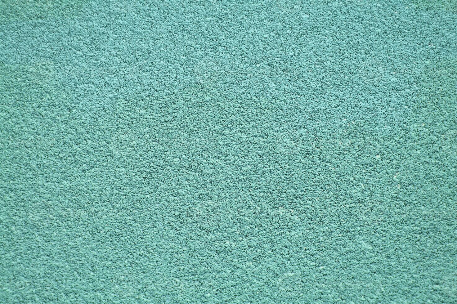Turquoise horizontal wall covered with plaster texture. photo