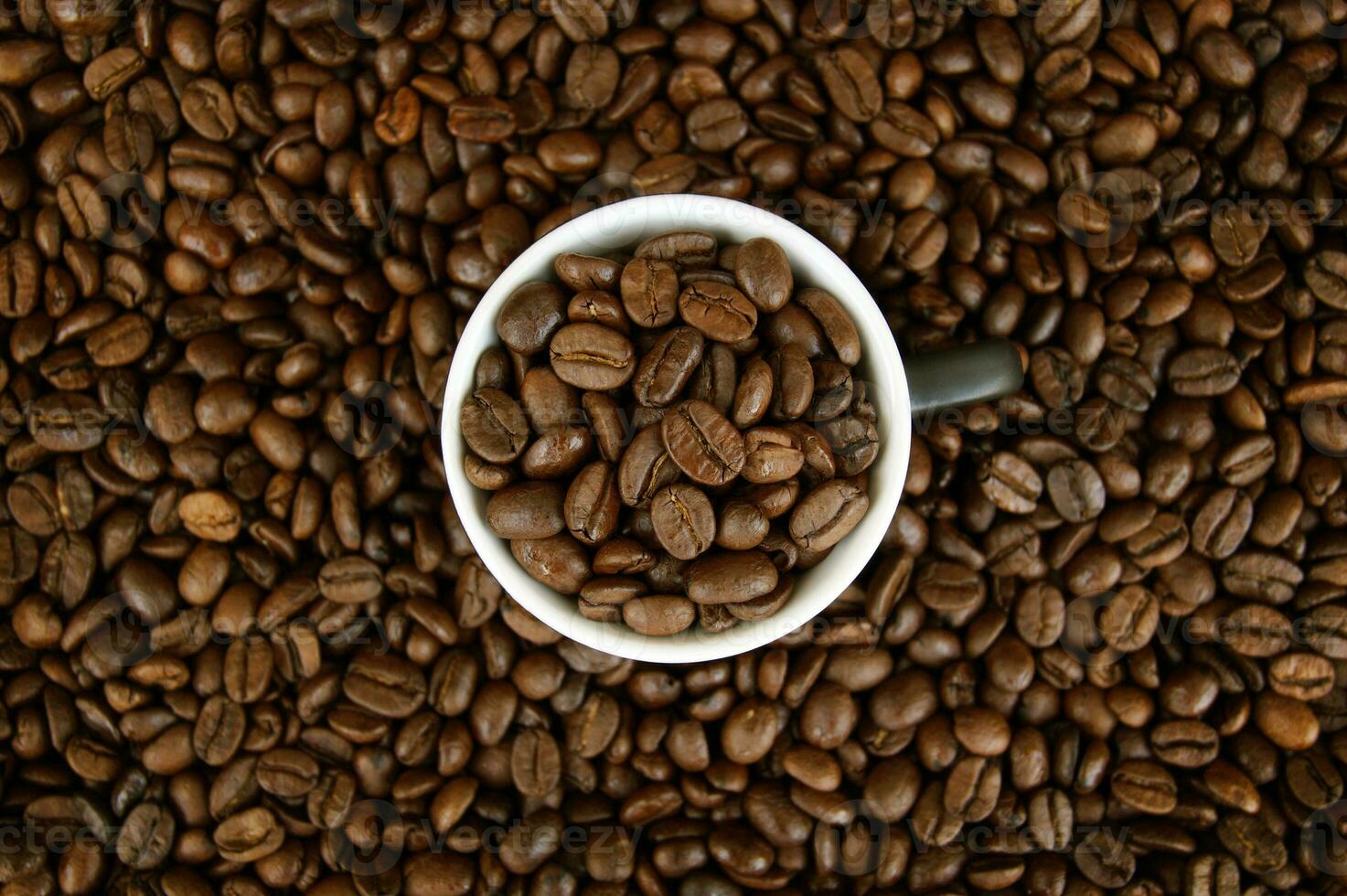 A cup filled with coffee grains. photo