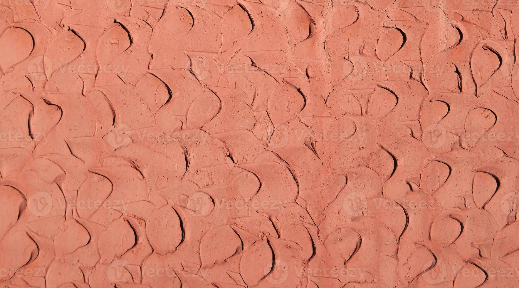 Red coral clay plaster walls, for use as a background and texture. photo