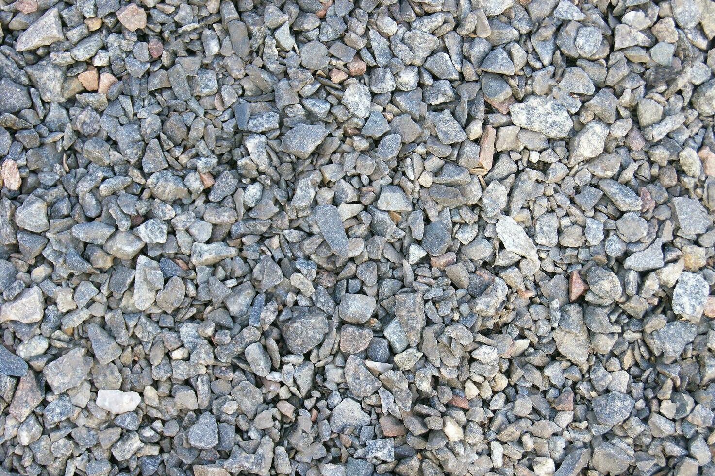 Small road stone background, dark gravel pebbles stone texture seamless texture photo