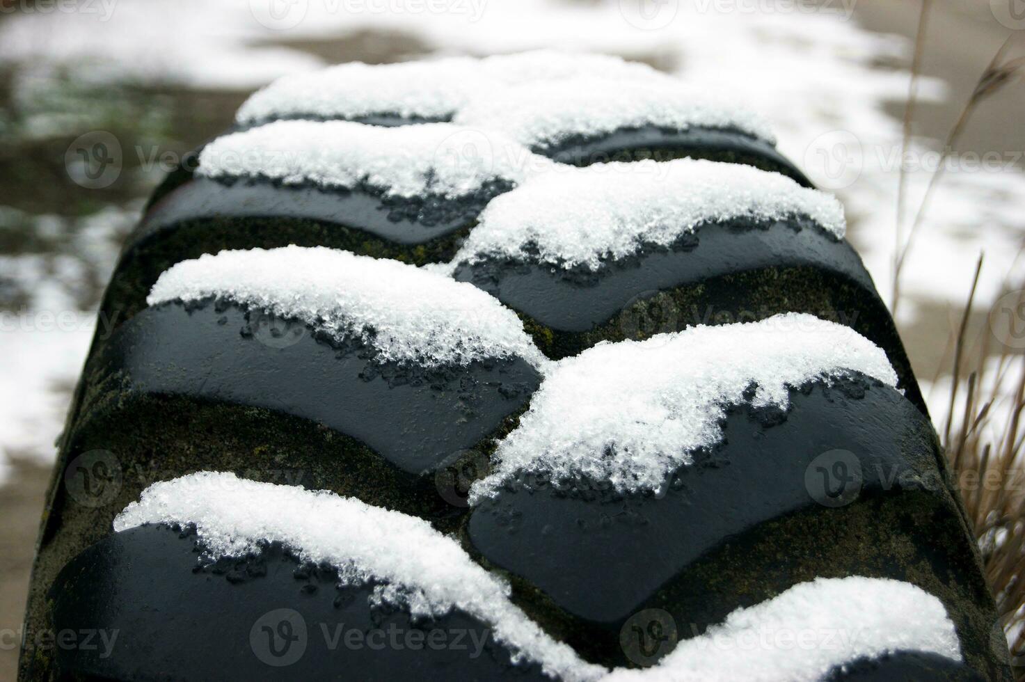 Texture of an old tire with snow in the grooves. photo