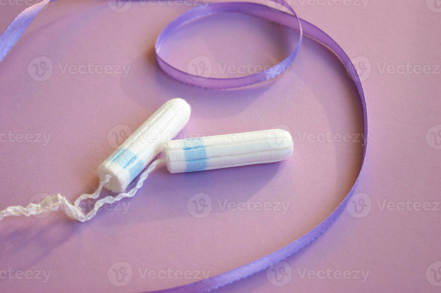 Menstrual tampons on menstruation period calendar with on lilac