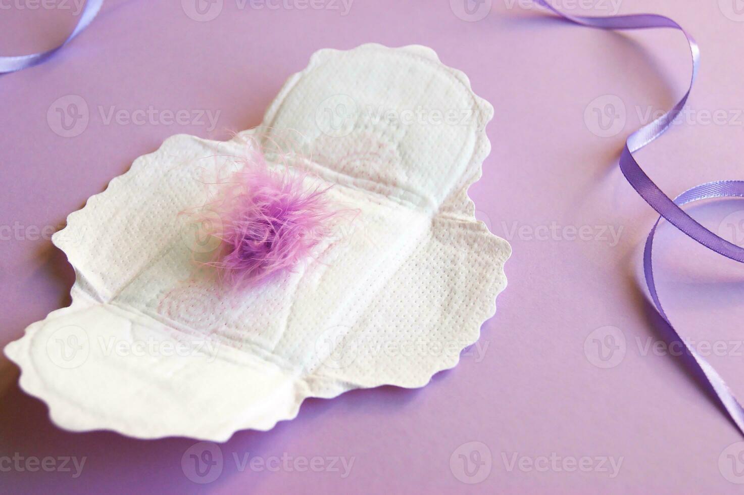 Menstrual pads with a fluff on a lilac background. photo