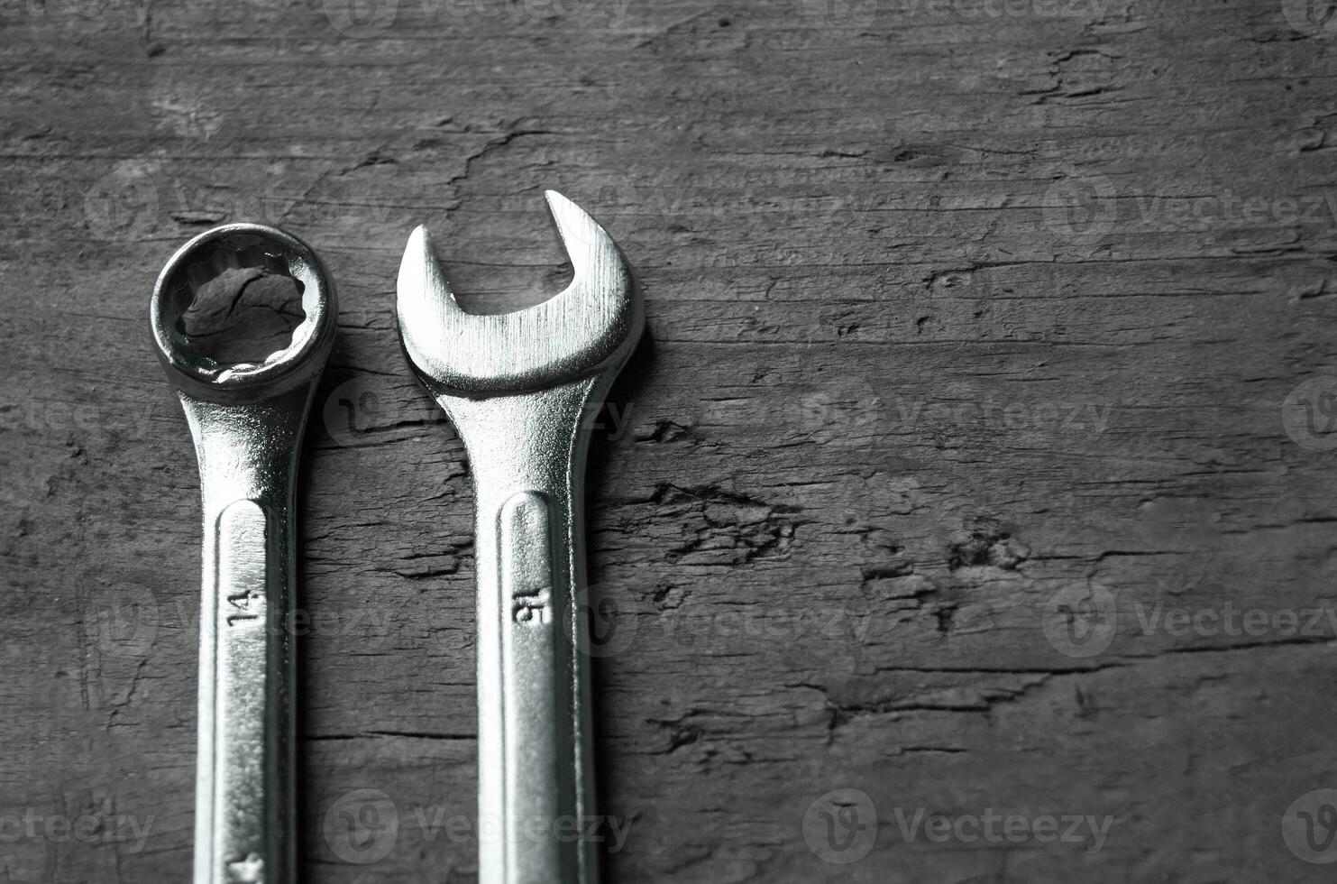 Wrenches of different sizes isolated on wood background photo