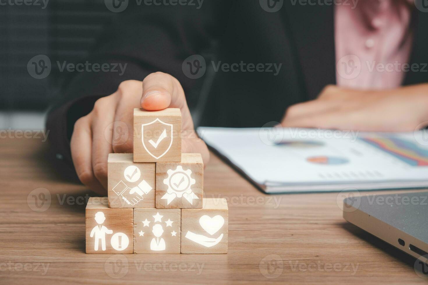 Credibility concept, Business woman hand holding wooden block on office desk with credibility icon on virtual screen. photo