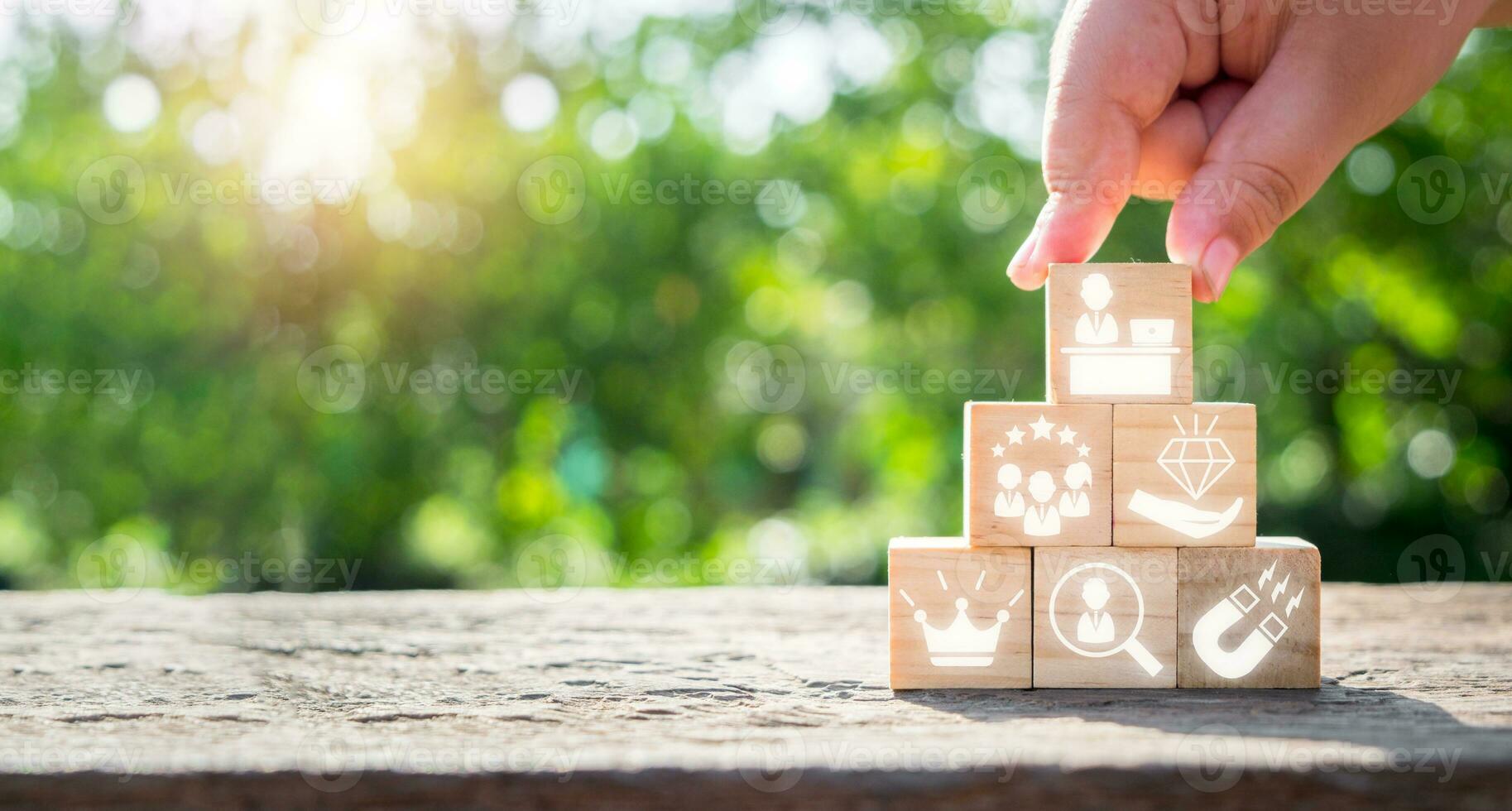 Employee Branding concept, Business hand holding wooden block with Employee Branding icon on virtual screen. photo