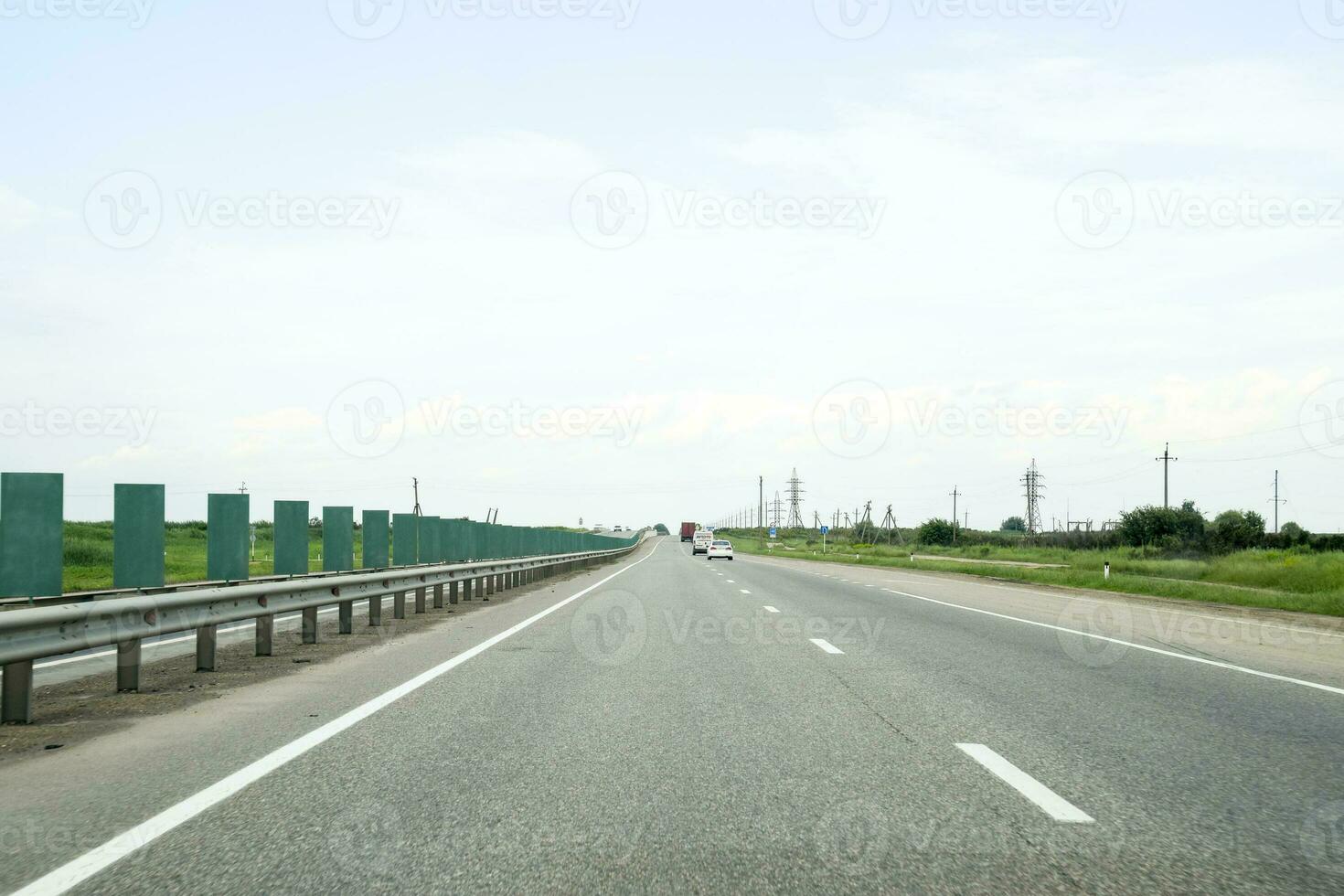 A one-way track, cars are driving along the road. photo