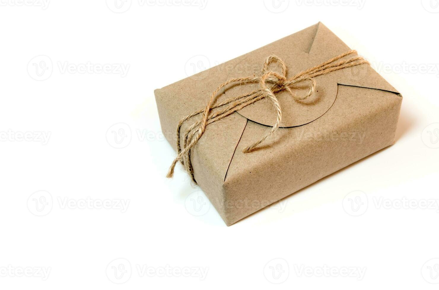 Gift box wrapped in kraft paper and rustic hemp as natural rustic style photo
