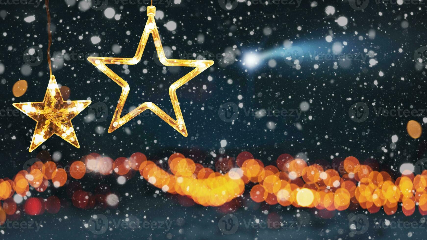 Amazing two stars Christmas lights on a winter forest background with bokeh golden lights, snow and a falling star, concept. Happy New Year and Christmas card, creative idea photo