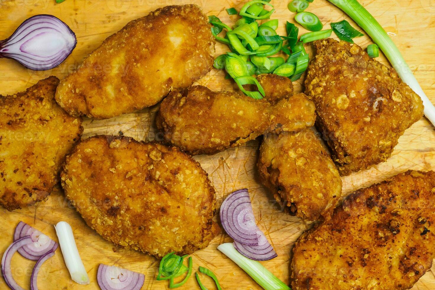 Fried chicken schnitzel on a cutting board. Homemade breaded schnitzel. Fried crispy chicken legs. photo