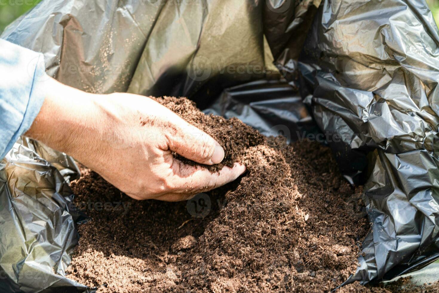 Hand holding peat moss organic matter improve soil for agriculture organic plant growing, ecology concept. photo