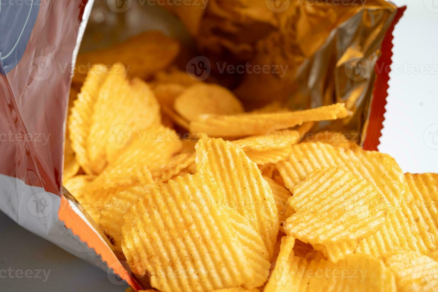 Potato chips, delicious BBQ seasoning spicy for crips, thin slice deep fried snack fast food in open bag. photo