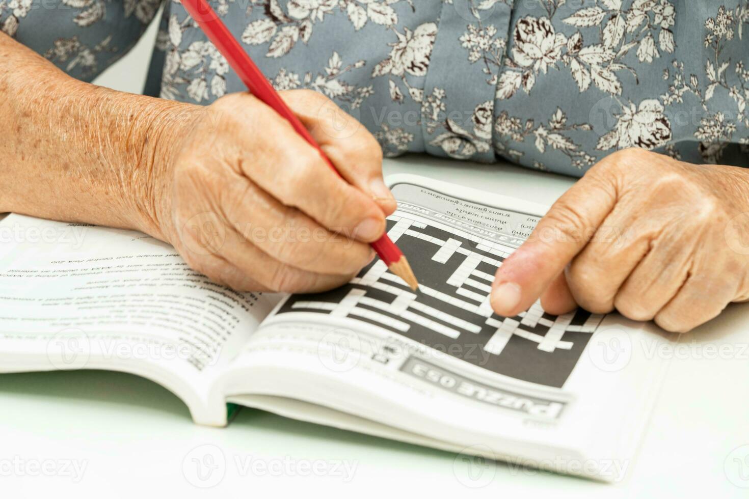 Bangkok, Thailand August 14, 2023 Alzheimer disease AD, Asian elderly woman playing sudoku puzzle game to practice for dementia prevention. photo